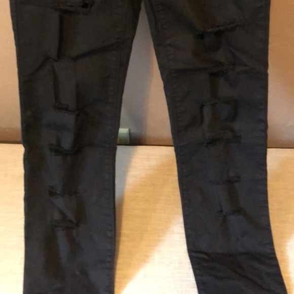 Size 4 Black stretchy jeans with holes in each leg. - Picture 2 of 5